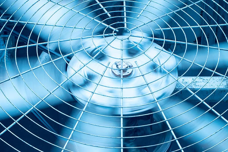Close up of HVAC fan blades spinning.